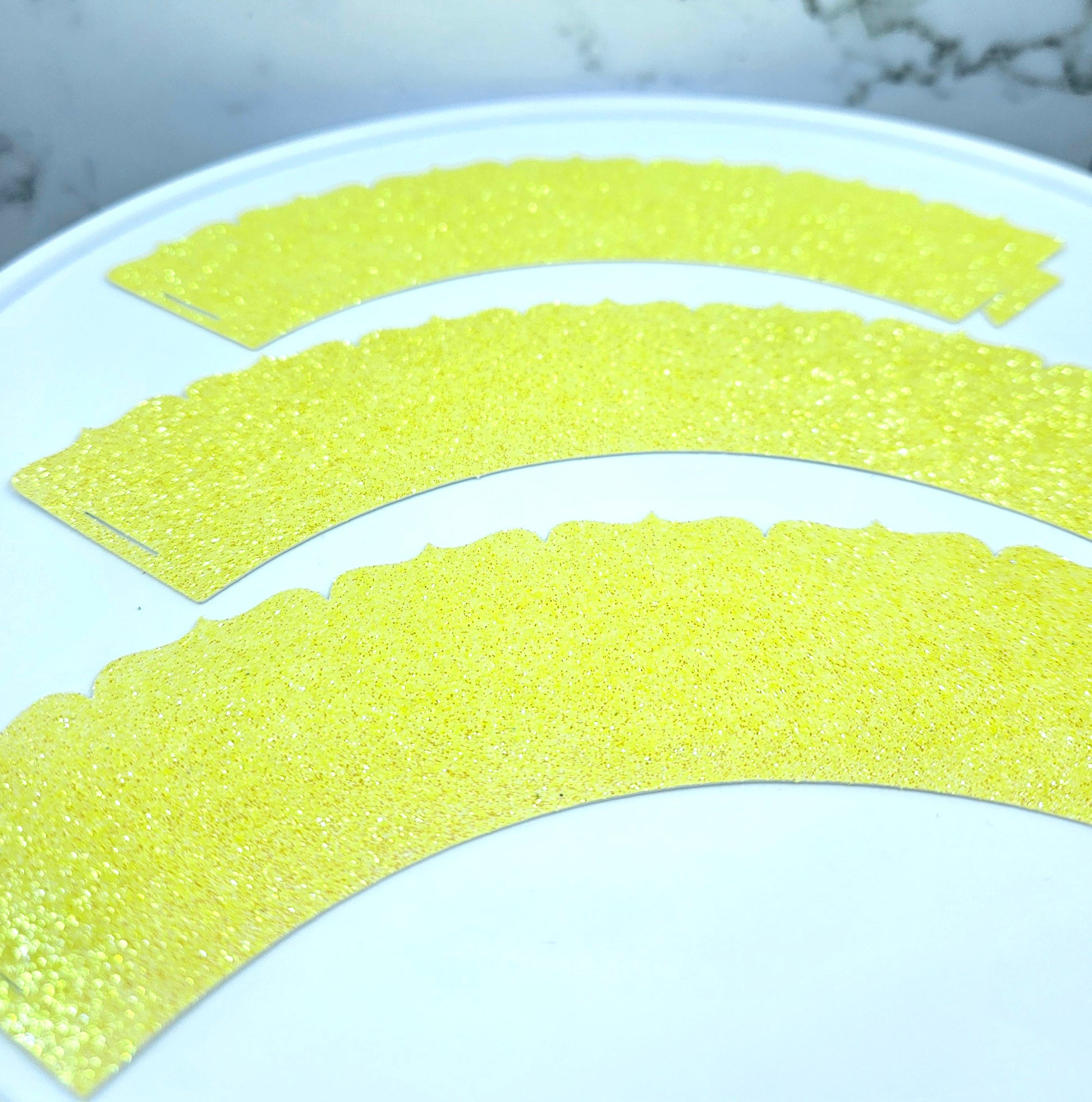 Yellow paper strips arranged in a semi-circular pattern on a white plate.